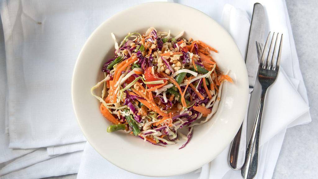 Thai Salad · Julienne carrot, red cabbage, green cabbage, tomatoes, green beans and chopped peanuts tossed with our delicious medium garlic lime dressing.