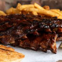 Full Slab Ribs · Served with garlic bread, cole slaw, pickle spear and choice of fries, baked potato, rice, o...