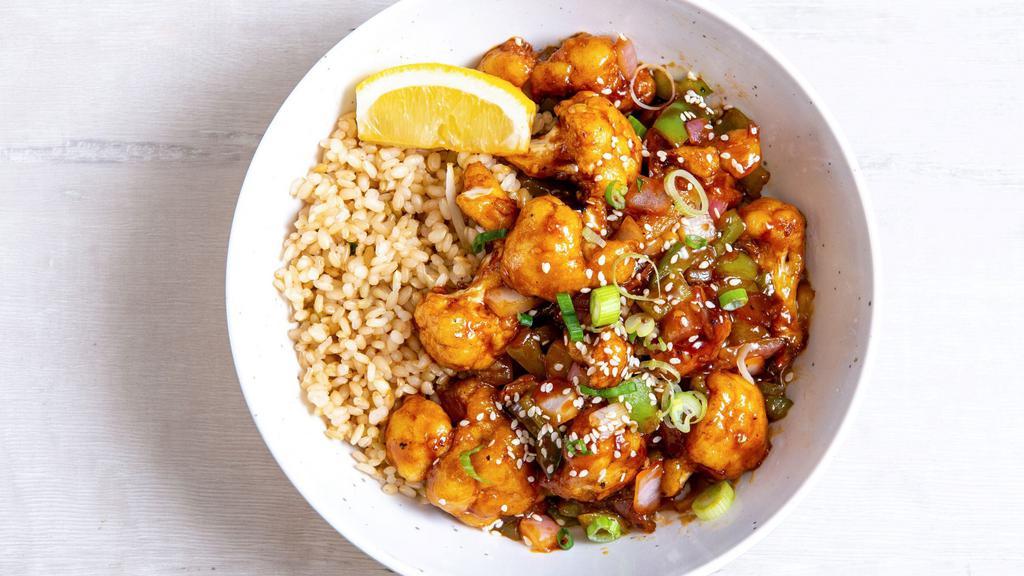 Orange Sesame Cauliflower · Flash-fried cauliflower with peppers & onions, green onions, sesame seeds, and our house-made orange sesame sauce. Served with a lemon wedge, and a base of your choice. (gluten-free)