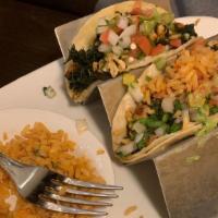 Popeye Tacos · Three tacos with corn tortillas spread with guacamole and filled with grilled chicken, spina...
