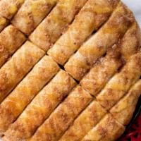 Cinnamon Bread · Sixteen pieces sweet breadstick covered in butter, and cinnamon sugar. Includes one side of ...