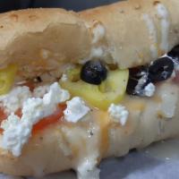 The Greek · Our three cheese blend of mozzarella, monterey jack, and cheddar with feta, black olives, to...