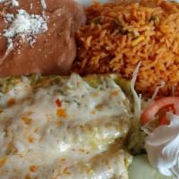 Enchiladas · Two soft rolled tortillas bathed in our green tomatillo, red guajillo or mole sauce. Topped ...