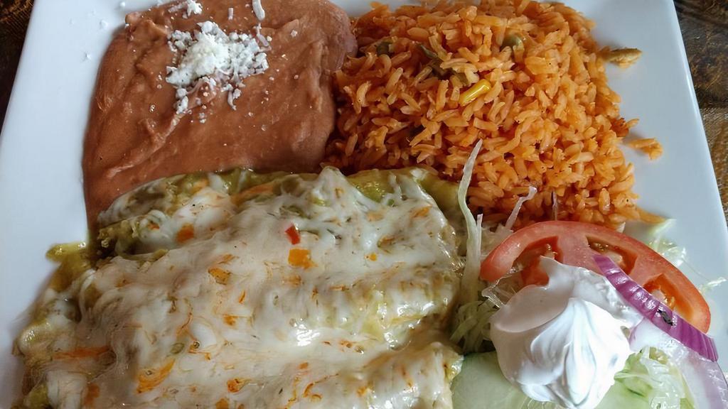 Enchiladas · Two soft rolled tortillas bathed in our green tomatillo, red guajillo or mole sauce. Topped with fresh Mexican cheese.