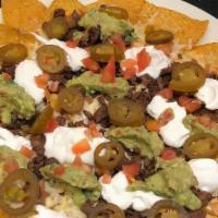 Nachos · Served with refried beans, tomato, jalapeño, cheese, sour cream and guacamole. Your Choice o...