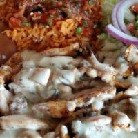 Pollo Jalisco · Grilled chicken cooked with mushrooms, chorizo and topped with cheese dip.