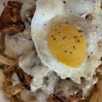 Breakfast Poutine · no sides. fried chicken, house-cut fries, three-cheese fondue, sausage gravy, one sunny egg.