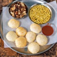 Pani Puri (8 Puris) · Puffy, crispy, mini-puris, served with potatoes, black chickpeas, tamarind chutney and speci...