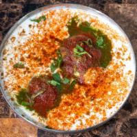 Dahi Vada · Lentil fritters soaked in creamy yogurt sauce and chutneys.