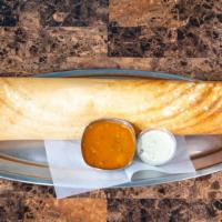 Paper Masala Dosa · Paper-thin, crispy, 2-foot long, lentil and rice crepe. Served with sambar and chutney. Serv...