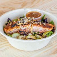 Salmon · Miso glazed salmon with cucumber, onion, and kiwi over mixed greens, with a miso sauce.