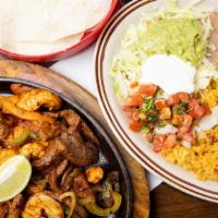 Las Fajitas Combo · Steak and chicken served with rice and beans (charro, black or refried) guacamole, sour crea...