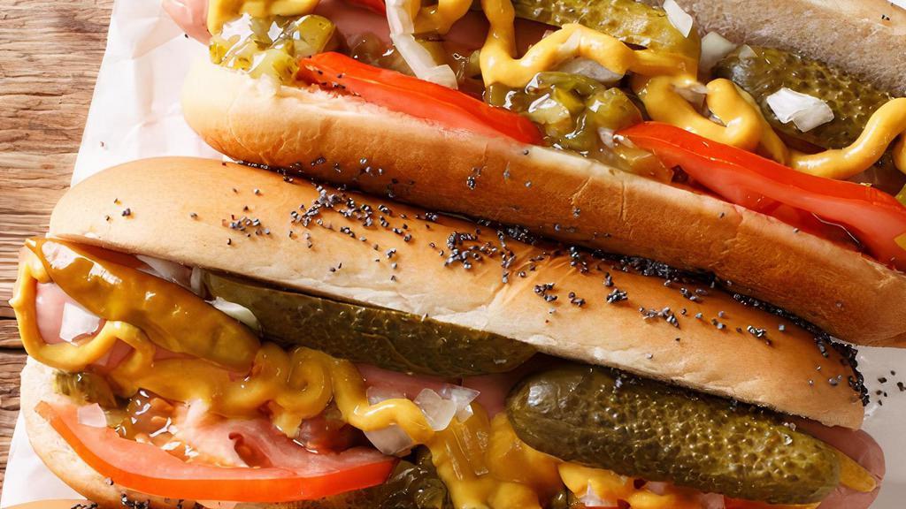 Chicago-Style Dogs · 2 Vienna beef hot dogs, topped with sport peppers, pickle spears, sliced tomato, mustard, celery salt, relish and onion on a poppy seed bun.