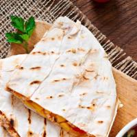 Cheese Quesadilla · A large flour tortilla stuffed with tomatoes and cheese. Served with sour cream and house-ma...