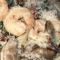 Shrimp Ersilia · Shrimp, fresh portobello mushrooms, sun-dried tomatoes and fresh spinach sautéed in a four c...