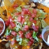 Nacho Platter · We combine nacho chips, your choice of meat, onion, jalapeños and shredded cheese. This plat...