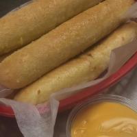 Bread Sticks · Five fluffy hot bread sticks, baked with parmesan cheese and served with nacho cheese sauce.