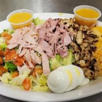 Chef Salad · Lettuce, shredded cheese, hard-boiled egg, tomato, croutons, ham, turkey and grilled chicken.