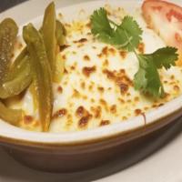 Queso Fundido · Choice of grilled chorizo or chicken with melted Mexican cheese, jalapenos, and choice of co...