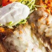 Enchiladas Mexicanas · Two chicken enchiladas smothered in our homemade mole sauce, topped with onions, Mexican che...