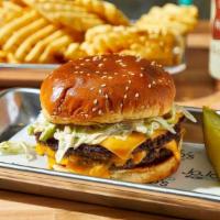 Smash Burger · Two four-ounce beef patties, American cheese, zip sauce, lettuce, pickles, sesame bun