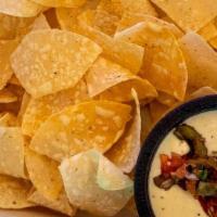 Queso Fundido · Homemade Queso, Roasted Green Peppers, Tomatoes & Red Onions. Served With House Fried Tortil...
