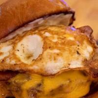 Sunrise Burger · Ground Chuck, American Cheese, Smoked Bacon, Fried Egg & Garlic Aioli. Served On A Grilled P...