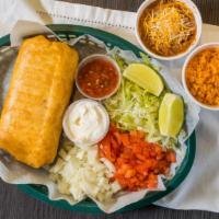 Grande Chimichanga Dinner · Choice of chicken, ground beef, or steak with an extra charge, with lettuce, tomatoes, shred...
