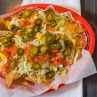 Nachos Supreme · Choice of chicken, ground beef, chili, or steak with an extra charge, with lettuce, tomato, ...