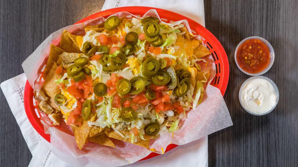 Nachos Supreme · Choice of chicken, ground beef, chili, or steak with an extra charge, with lettuce, tomato, raw onion, jalapenos, cheese, sour cream, side of salsa.