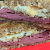 Reuben · Sliced corned beef, sauerkraut, melted swiss cheese and 1000 Island on marbled rye bread.