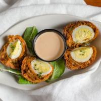 Scotch Egg · Hard-boiled egg wrapped in seasoned sausage then lightly breaded and fried to give it a warm...