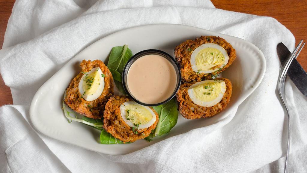 Scotch Egg · Hard-boiled egg wrapped in seasoned sausage then lightly breaded and fried to give it a warm shell with a cool center. Served with chili aioli dipping sauce.