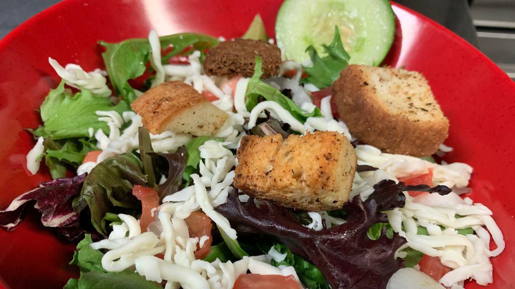 House Salad · Field greens with diced onion, diced tomato, three cheese blend, and croutons. Add large size for an additional charge.