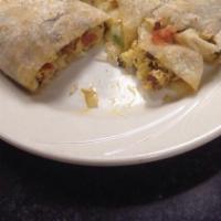 Breakfast Quesadilla · A huge tortilla filled with scrambled eggs, ham, green onions, and melted cheese. Served wit...