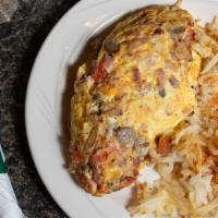 Hungryman Omelette · Bacon, sausage, ham, mushrooms, onions, and tomatoes. Topped with jack and cheddar cheese.