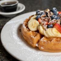 Ultima Waffle · Bananas, strawberries, blueberries, peaches, nuts and whipped cream.