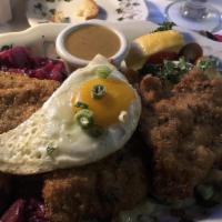 Wiener Schnitzel Ala Holstein · Tender, golden brown veal medallions with sautéed spatzles and braised red cabbage.

Consumi...