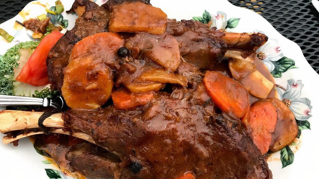 Lamb Shanks · Twin new zealand lamb shanks braised then baked until fork tender served with root vegetables and savory lamb sauce