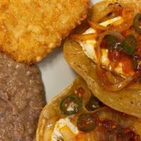 Huevos Rancheros · Served with beans and tortillas.