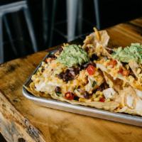 Ma'S Nachos · Our home made cheese sauce tops crispy chips along with black bean and corn salsa and fresh ...