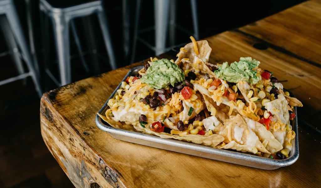 Ma'S Nachos · Our home made cheese sauce tops crispy chips along with black bean and corn salsa and fresh avacado mash.
