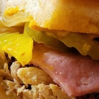 Cubano Sandwich · Pulled Pork, Wisconsin Smoked Ham, Wisconsin Swiss, Pickles & Mustard on a Garlic Buttered R...