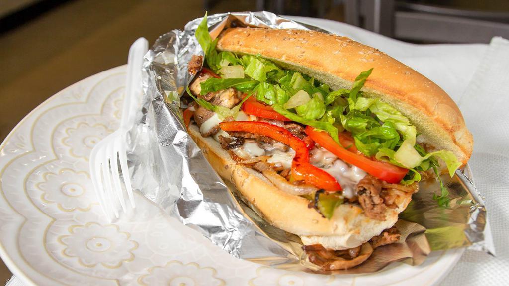 Philly Steak Sub · Sliced Chicken, Grilled Onions, Green pepper, Mushroom, Cheese, Lettuce, Tomato.