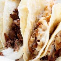 Philly Style Tacos · Your choice of rib eye steak or roasted chicken, provolone cheese, caramelized onions & garl...