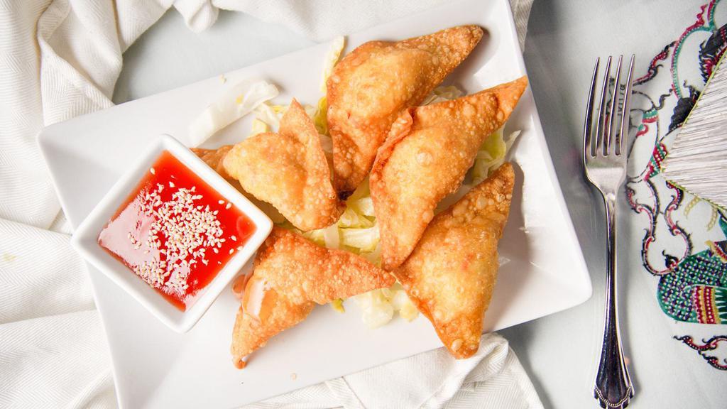 Crab Rangoon · Six (6) fried wonton skins filled with mixed of cream cheese and imitation crab meat. Serve with red sweet and sour sauce.