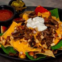 The Nachos · Made-to-order tortilla chips, red onions, queso, jalapeno, olives, tomatoes, and sour cream ...