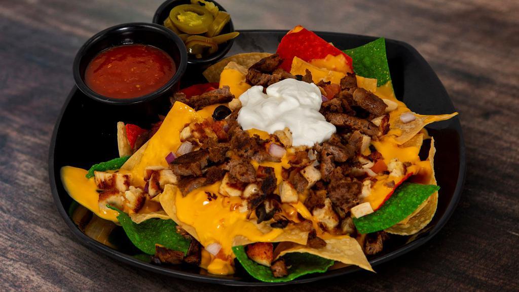 The Nachos · Made-to-order tortilla chips, red onions, queso, jalapeno, olives, tomatoes, and sour cream + chicken or beef for an extra charge. Add chicken or beef for an additional charge.