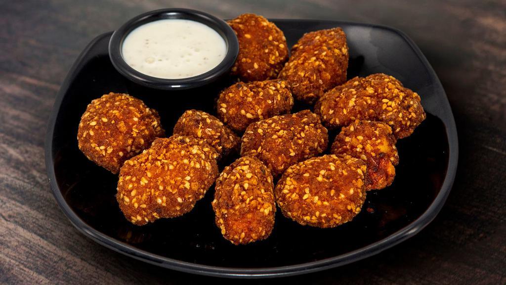 Sriracha Chicken Bites · Chicken battered with a sriracha sesame seed breading served with ranch.