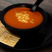 Tomato Bisque · Blended tomatoes, basil, and onions topped with parmesan cheese.